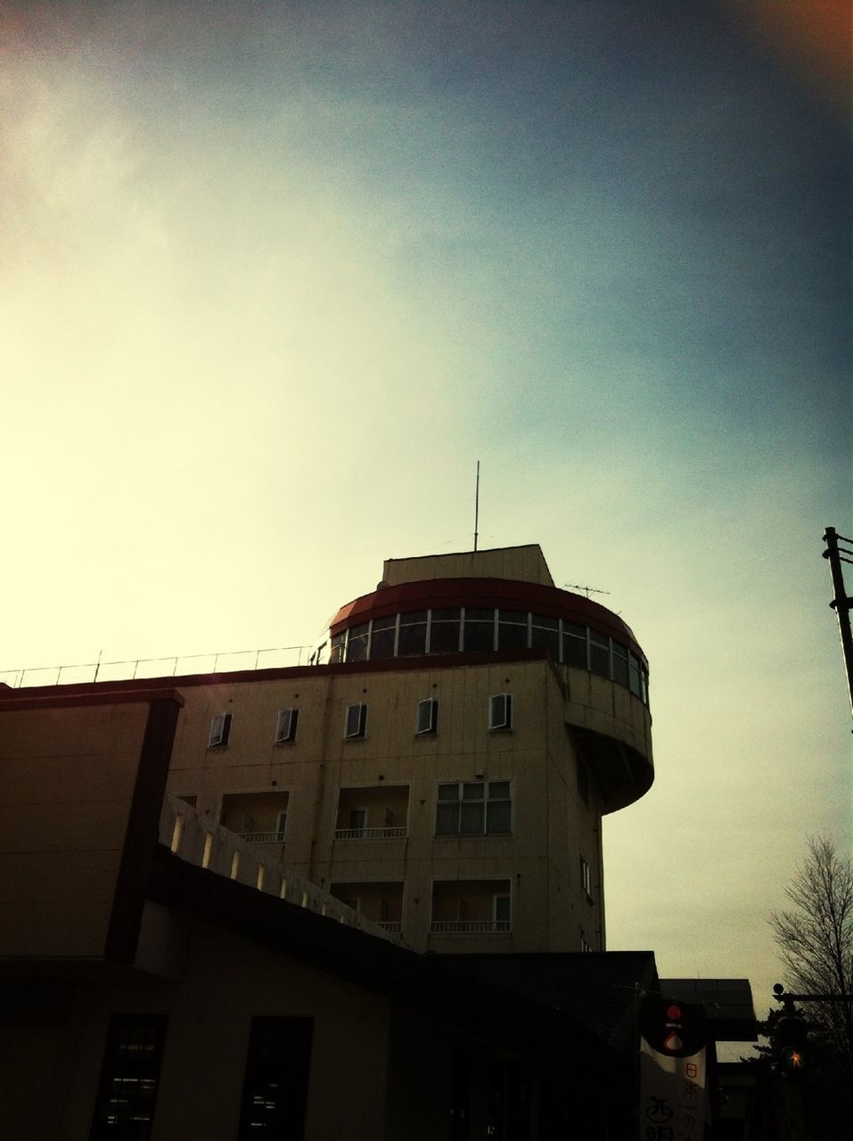 architecture, building exterior, built structure, low angle view, sky, high section, building, city, residential building, clear sky, residential structure, window, outdoors, tower, no people, copy space, day, house, cloud, tall - high