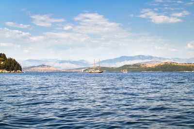 Sailing ship in the strait between the greek island of corfu and the mainland of albania, panorama