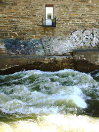 Water flowing through stone wall