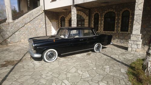 Vintage car on street against building