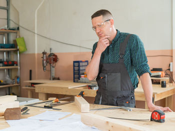 Side view of young man working at home