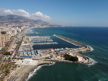 High angle view of sea and city against sky