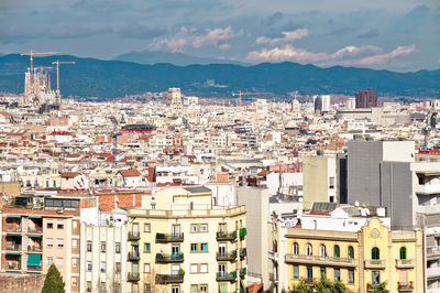 High angle view of townscape by sea against sky, barcelona 