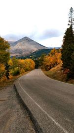 Empty road leading towards mountains