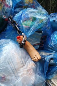 Broken mannequin on garbage