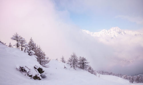 Scenic view of snow covered mountains against sky