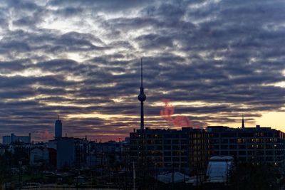 View of cityscape against cloudy sky