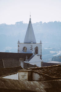 Tower amidst buildings against sky