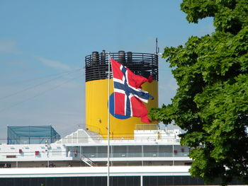 Low angle view of american flag against sky