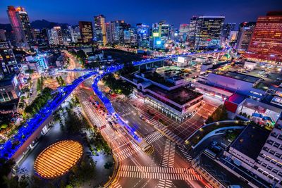 High angle view of illuminated city buildings at night