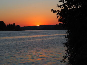 Scenic view of lake against orange sky