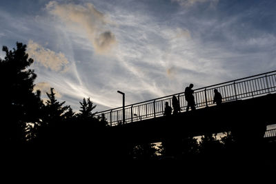 Low angle view of silhouette bridge against sky