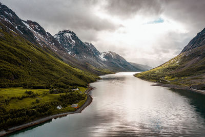 Scenic view of lake amidst mountains against sky