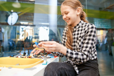 Smiling girl playing with toys