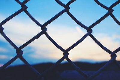 Chainlink fence seen through chainlink fence