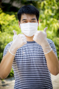 Portrait of man gesturing while wearing mask and gloves