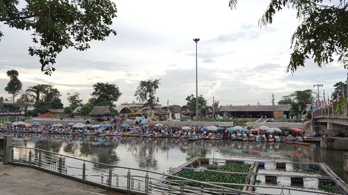 People on shore against sky