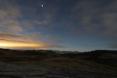 Scenic view of field against sky at sunset