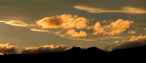 Low angle view of silhouette mountain against dramatic sky