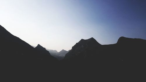 Silhouette mountain range against clear sky