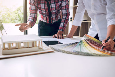 Midsection of business colleagues working in office