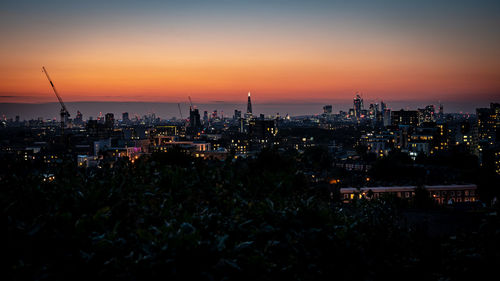 Silhouette buildings against sky during sunset