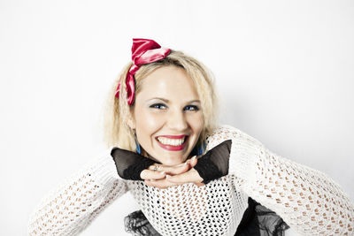 Portrait of young woman against white background