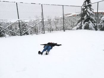 Full length of child on snow covered field