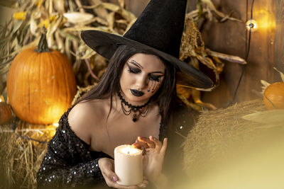 Portrait of young woman with pumpkin