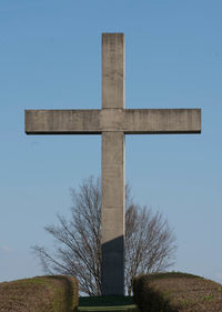 Low angle view of cross against clear blue sky