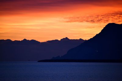 Scenic view of sea against romantic sky at sunset