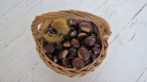 High angle view of chestnuts in wicker basket on table