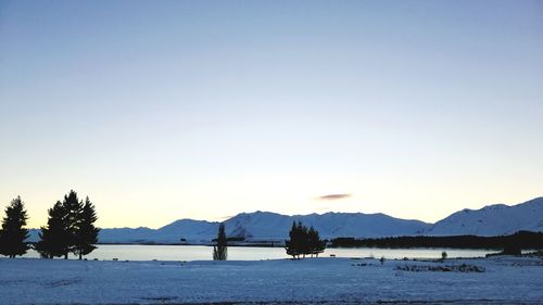 Scenic view of lake against clear sky during winter