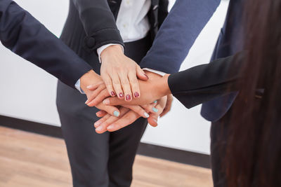 Midsection of couple holding hands