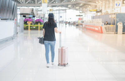 Rear view of woman walking in airport