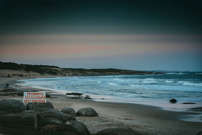 Scenic view of beach against sky during sunset