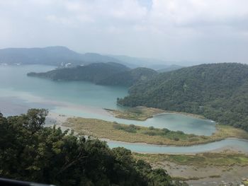 High angle view of trees and mountains against sky