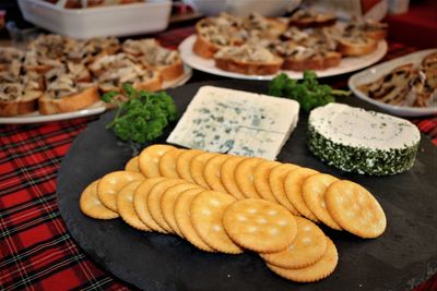 Close-up of buffet food with cheese and biscuits in foreground