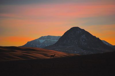 Scenic view of silhouette mountains against sky during sunset