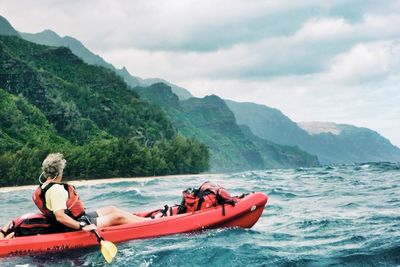 Tourists sitting on boat in sea