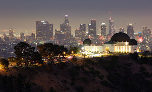 Fourth of july fireworks over griffith observatory with the los angeles skyline in the distance