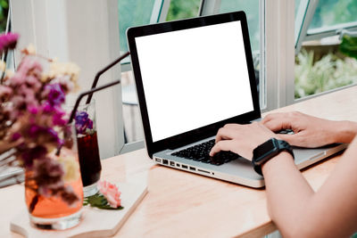 Low angle view of woman using mobile phone on table