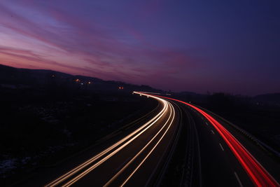 High angle view of light trails on highway at night