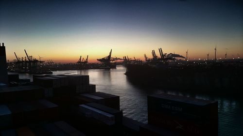 Scenic view of harbor against sky during sunset