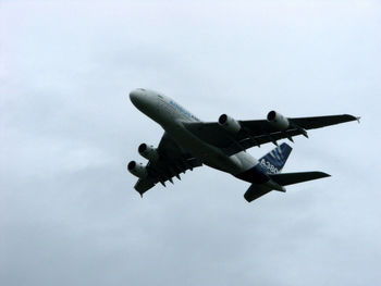 Low angle view of airplane flying in sky