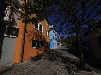 Street amidst buildings against sky