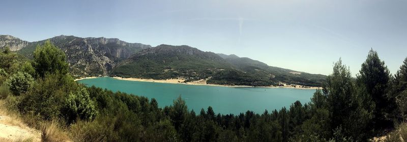 Scenic view of lake and mountains against clear sky