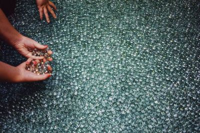High angle view of woman holding marbles