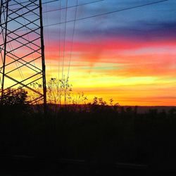 Silhouette trees against orange sky during sunset