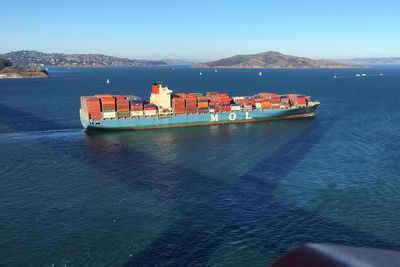 Ship sailing on sea against clear sky